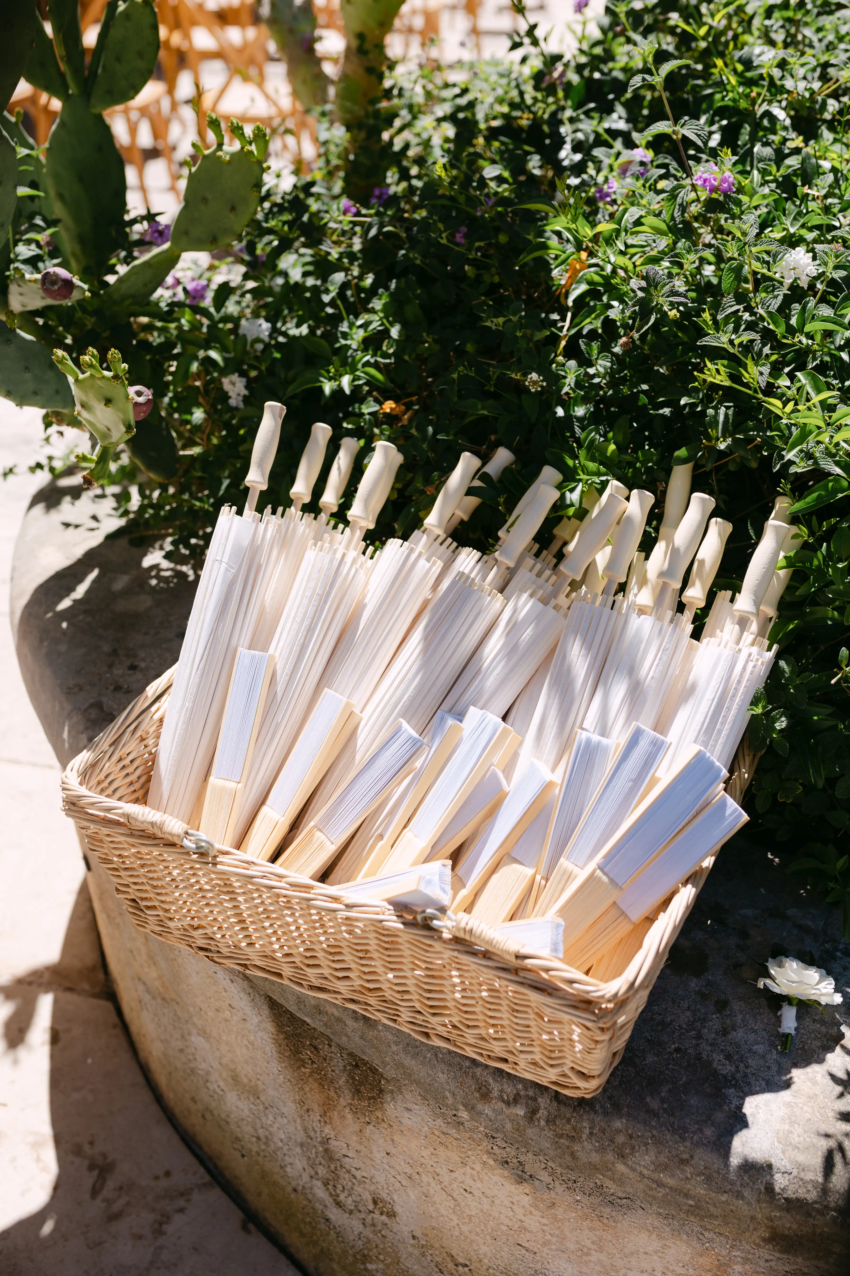 Elegant wedding ceremony fans displayed outdoors at a luxury Sicilian destination wedding